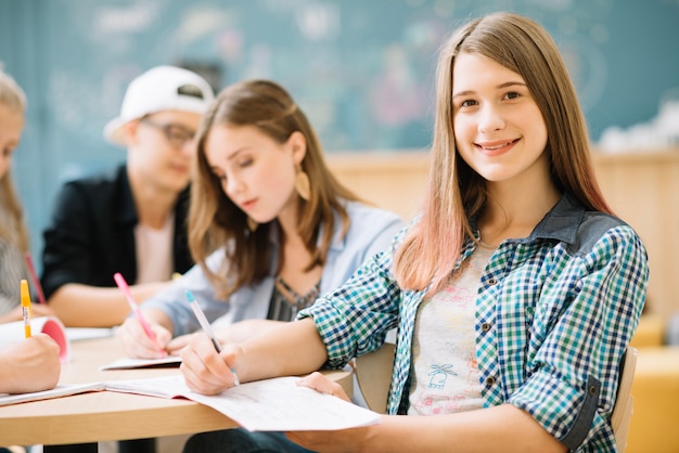 Smiling girl posing with classmates