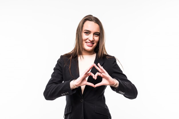 Smiling girl shows heart sign isolated over white