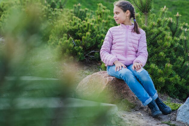 Smiling girl sitting outdoors