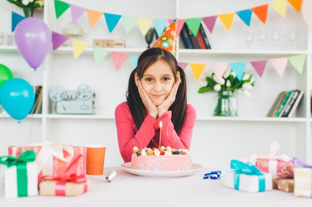 誕生日ケーキを持つ少女の笑顔