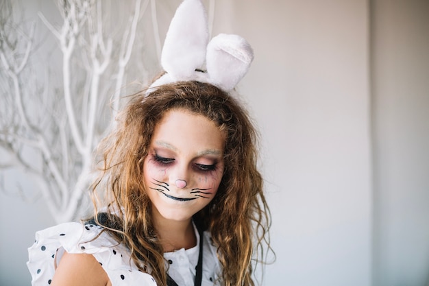 Smiling girl with hare face paint