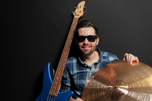 Smiling guitarist with cymbal