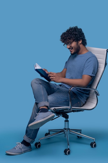 Smiling guy focused on reading his notes