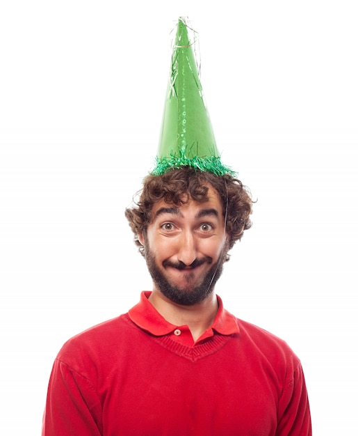 Free photo smiling guy wearing a green party hat