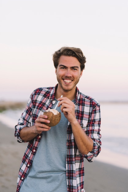 Smiling guy with coconut