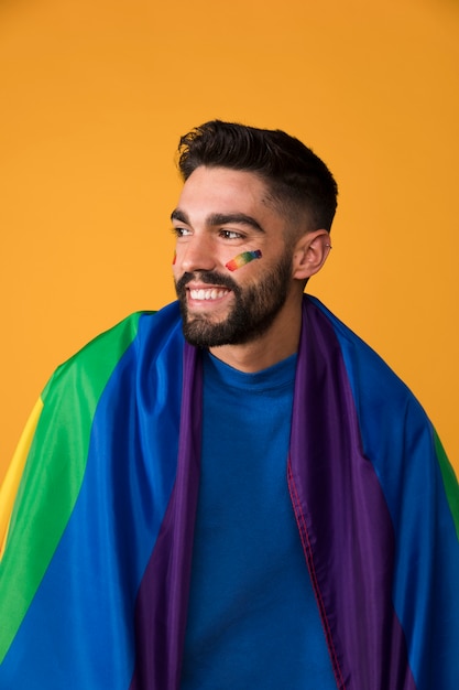 Free photo smiling guy with lgbt flag