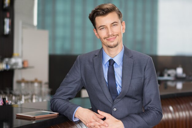 Smiling Handsome Businessman at Cafe Counter