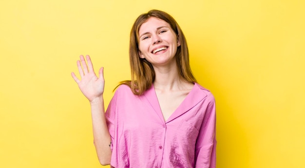 Smiling happily and cheerfully waving hand welcoming and greeting you or saying goodbye