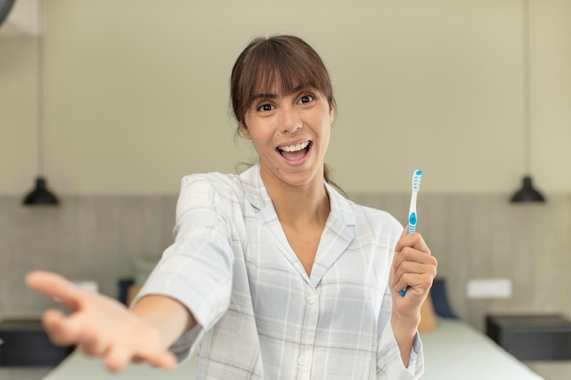 Free photo smiling happily and offering or showing a concept