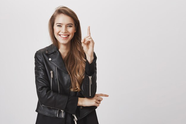 Smiling happy, attractive woman raise index finger have idea