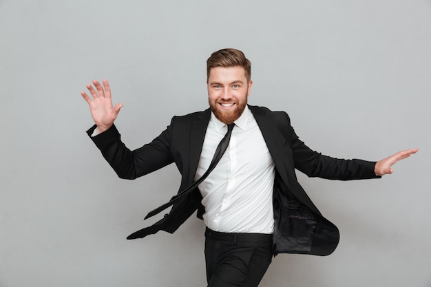 Smiling happy businessman in suit posing