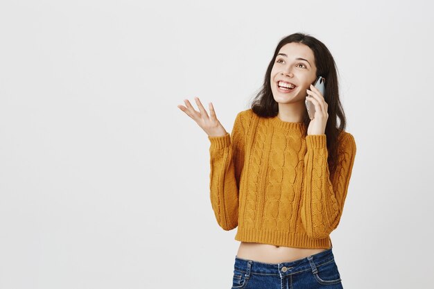 Smiling happy girl talking on mobile phone