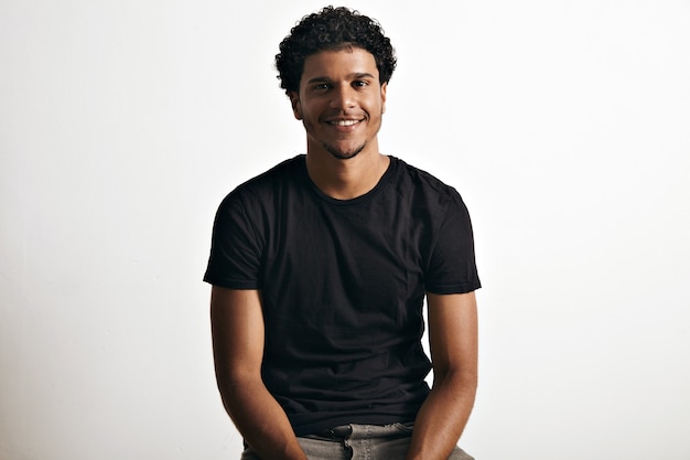 Smiling happy healthy African American model wearing a blank cotton short-sleeved t-shirt isolated on white