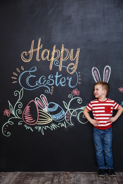 Free photo smiling happy little boy with bunny ears standing