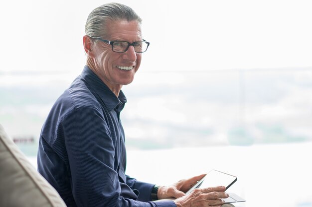 Smiling Happy Senior Man Using Digital Tablet