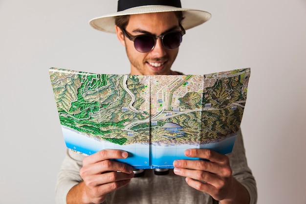 Free photo smiling hipster man with map