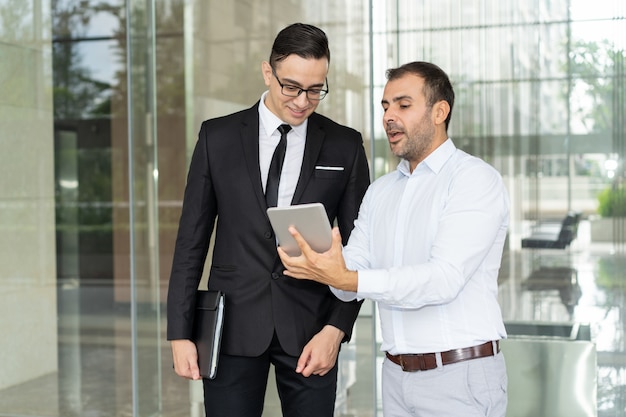 Smiling IT company managers discussing new product