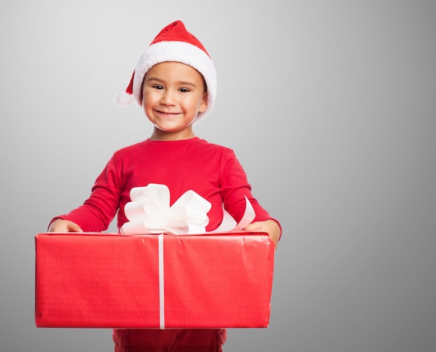 Smiling kid holding a large gift