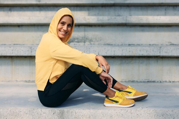 Smiling lady in activewear enjoying outdoor workout