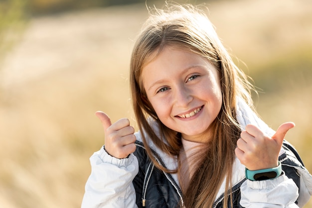 Smiling little girl showing ok sign