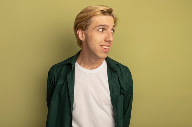 Smiling looking at side young blonde guy wearing green t-shirt