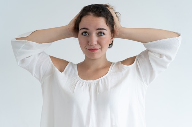 Smiling lovely woman clutching head