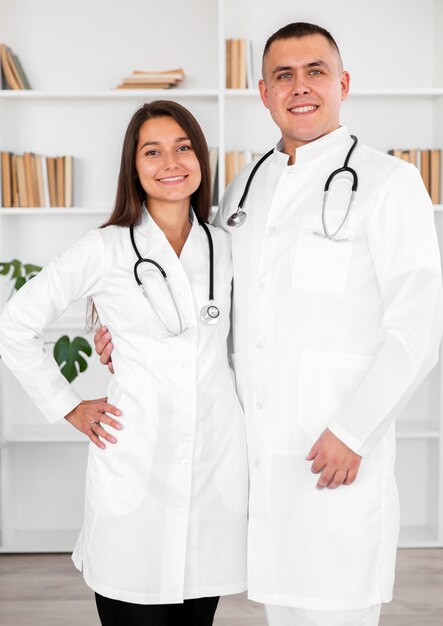 Medico maschio e femminile sorridente che esamina fotografo