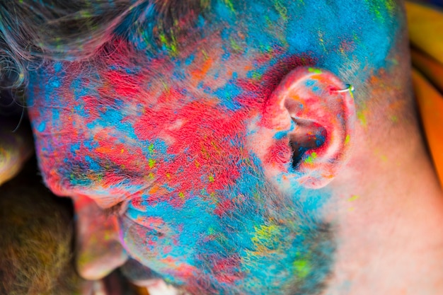 Smiling man in blue pink dye