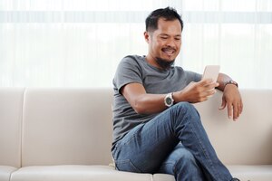 Smiling man checking his phone