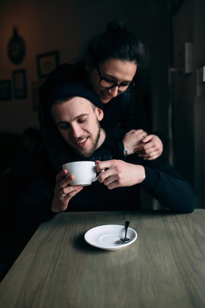 Smiling man drinking a cup of coffee