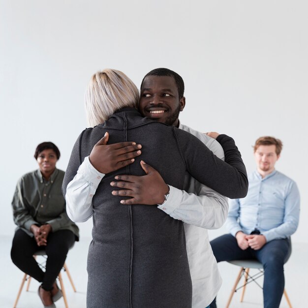 Smiling man embracing woman