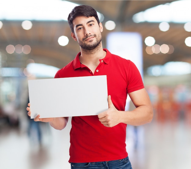 Smiling man holding a blank sign