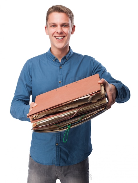 Free photo smiling man holding a bunch of working folders