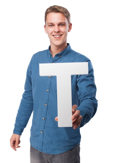 Smiling man holding the letter "t"