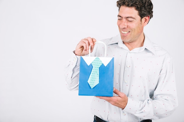 Free photo smiling man holding present