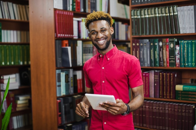 Smiling man holding tablet and posing