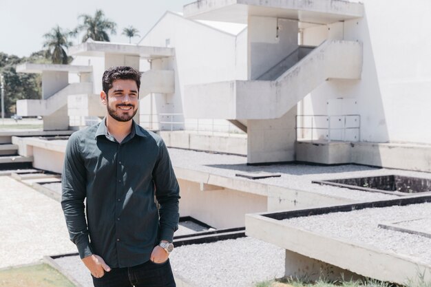 Smiling man near modern building