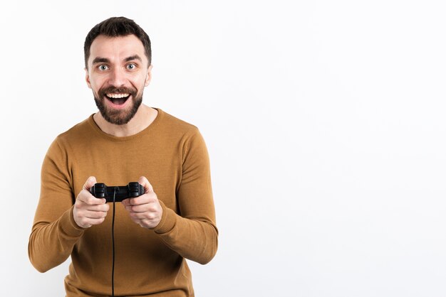 Smiling man playing with game controller