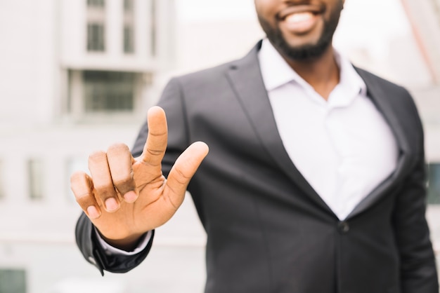 Smiling man pointing at camera