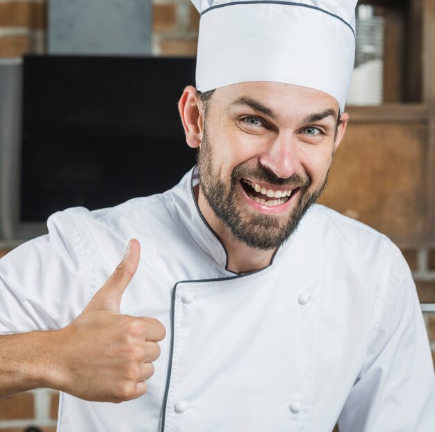 Smiling man showing thumb up sign