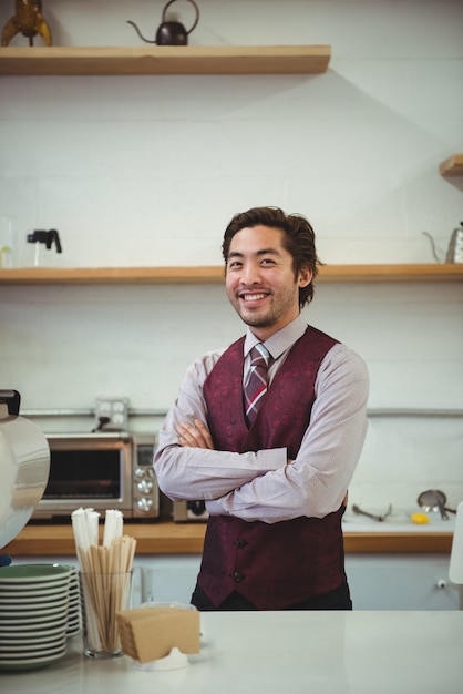 Smiling man standing with arms crossed