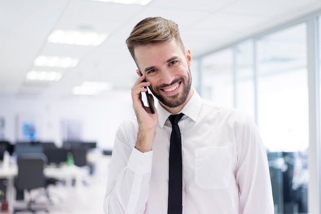 Smiling man talking on his phone