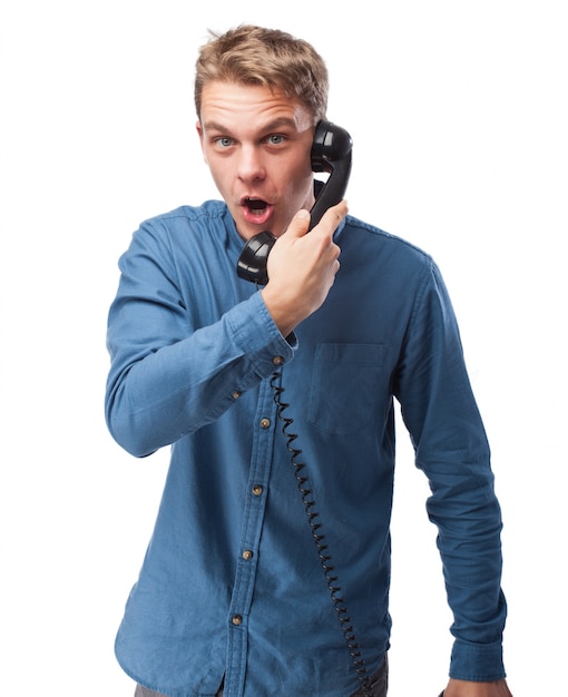 Free photo smiling man talking on an old phone