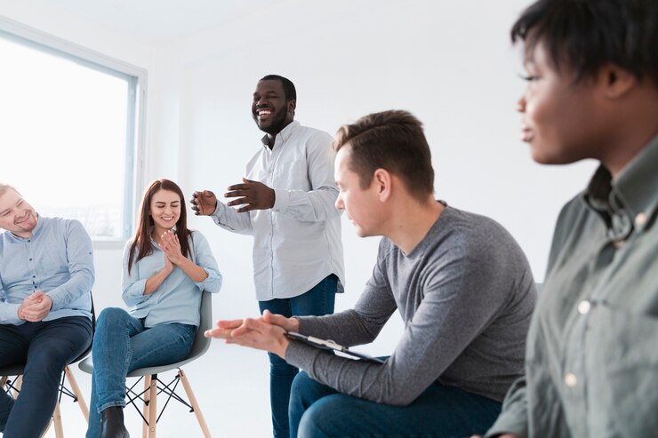 Free Photo smiling man talking with rehab patients
