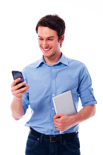 Smiling man using wireless devices