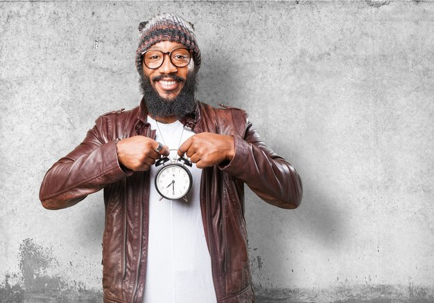 Smiling man with an alarm clock