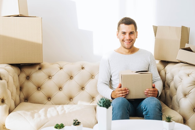 Smiling man with cardboard box