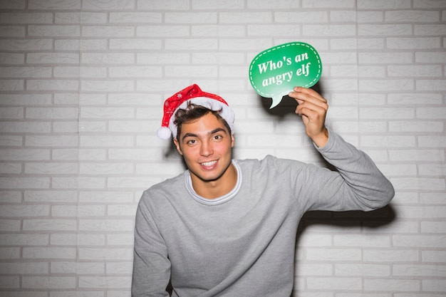 Free photo smiling man with christmas sign