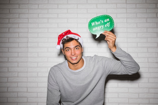 Smiling man with Christmas sign 