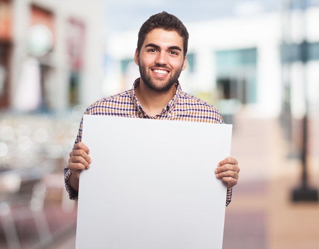 Free photo smiling man with clear sheet of paper